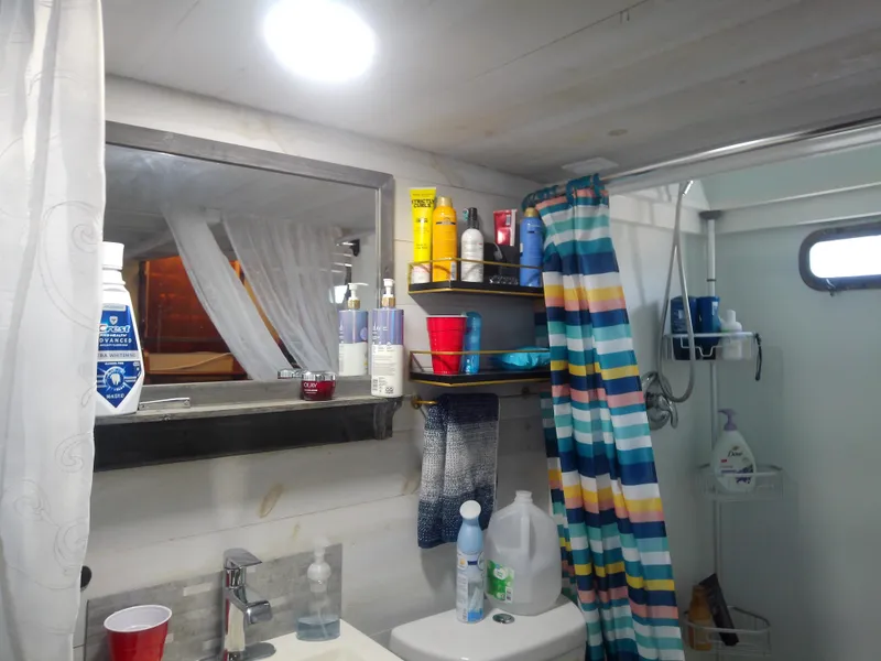 Slide: The Image of Bathroom interior of a 1975 Marine Trader 40 Double Cabin with colorful shower curtain. - 45
