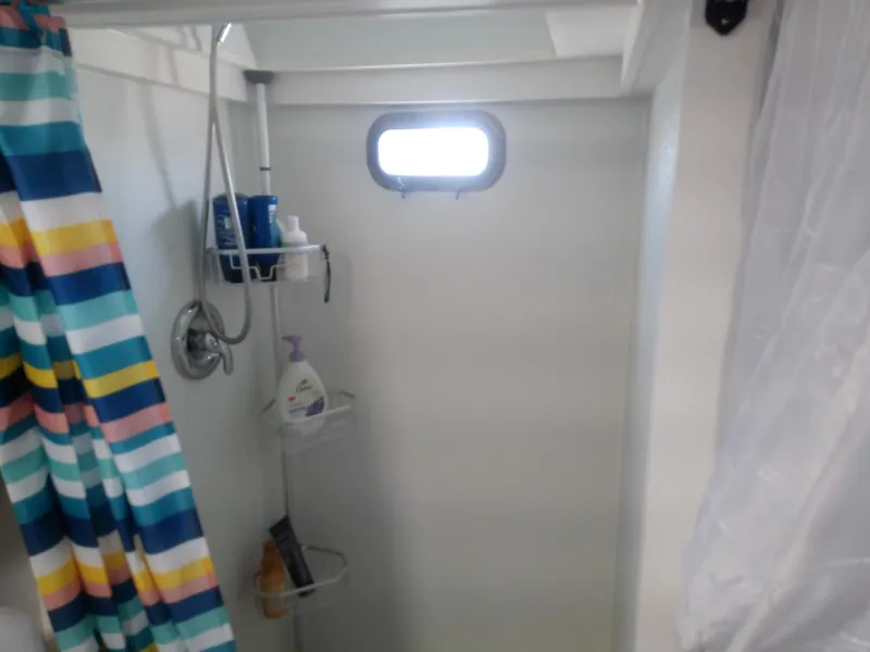 Slide: The Image of Shower area in 1975 Marine Trader 40 Double Cabin with colorful curtain and porthole. - 46
