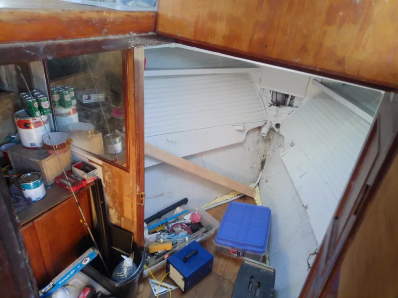 Slide: The Image of Interior of 1975 Marine Trader 40 Double Cabin with cluttered storage and supplies. - 47