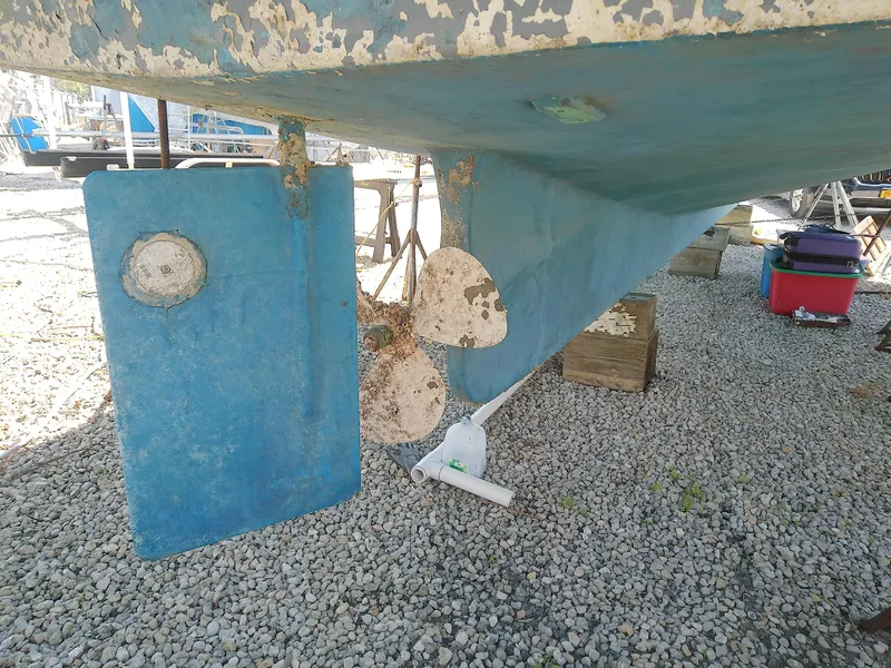 Slide: The Image of 1975 Marine Trader 40 Double Cabin boat hull and propeller on gravel. - 5