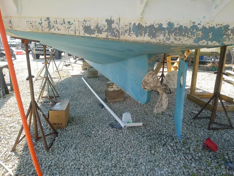 Slide: The Image of 1975 Marine Trader 40 Double Cabin hull on dry dock, showing wear and maintenance needs. - 6