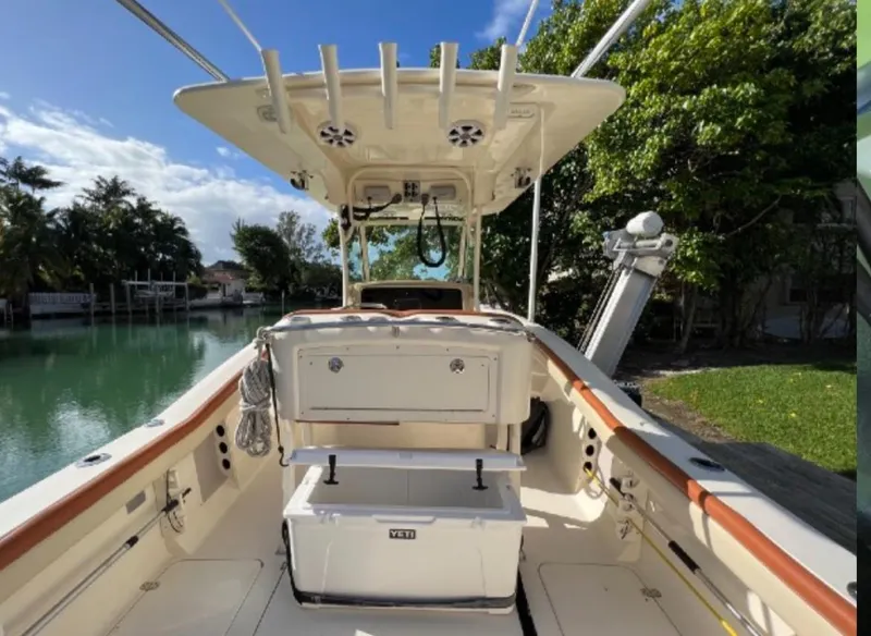 Slide: The Image of 2013 Scout 275 LXF boat interior with fishing rod holders and Yeti cooler. - 10