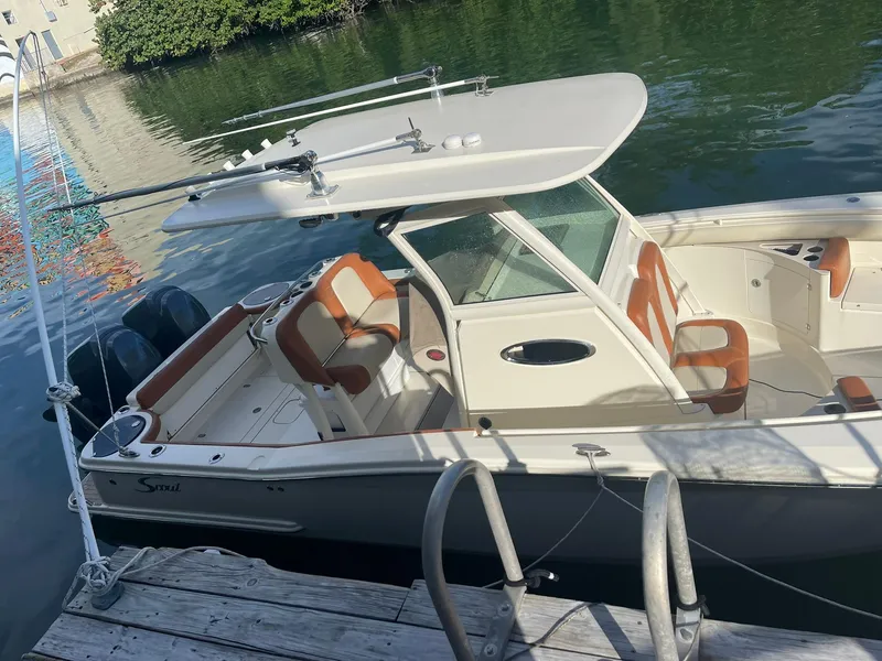 Slide: The Image of 2013 Scout 275 LXF boat docked, featuring dual engines and sleek design. - 20