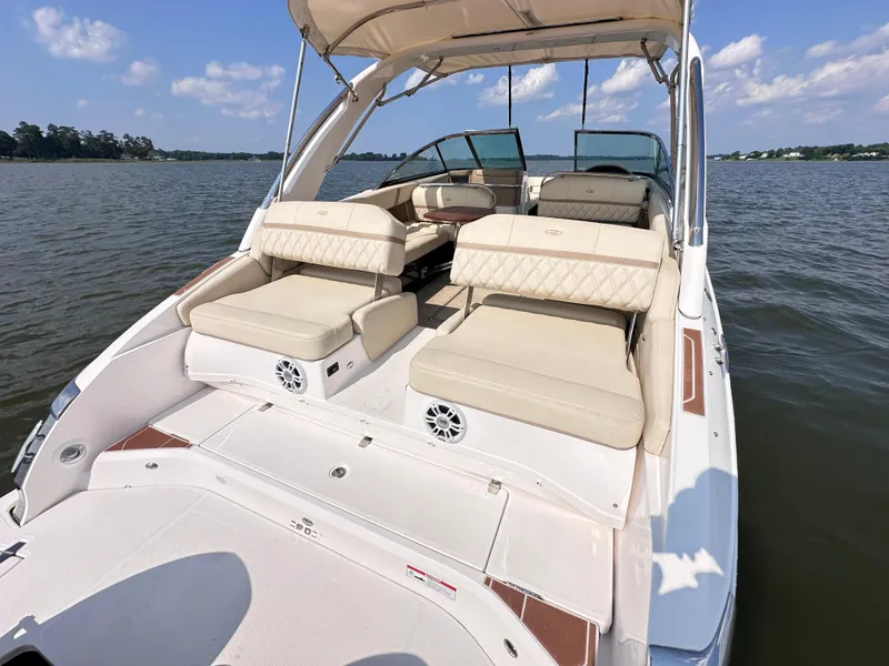 Slide: The Image of 2019 Regal 29 OBX boat with spacious seating on a calm lake. - 10