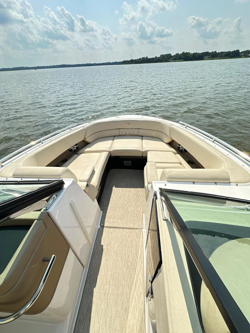 Slide: The Image of 2019 Regal 29 OBX boat with spacious seating on a calm lake. - 11