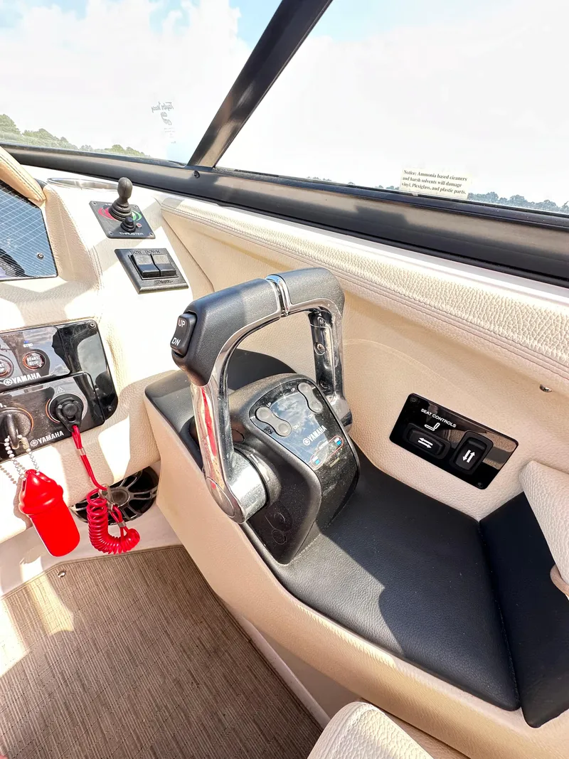 Slide: The Image of 2019 Regal 29 OBX boat cockpit with steering wheel and control panel. - 17