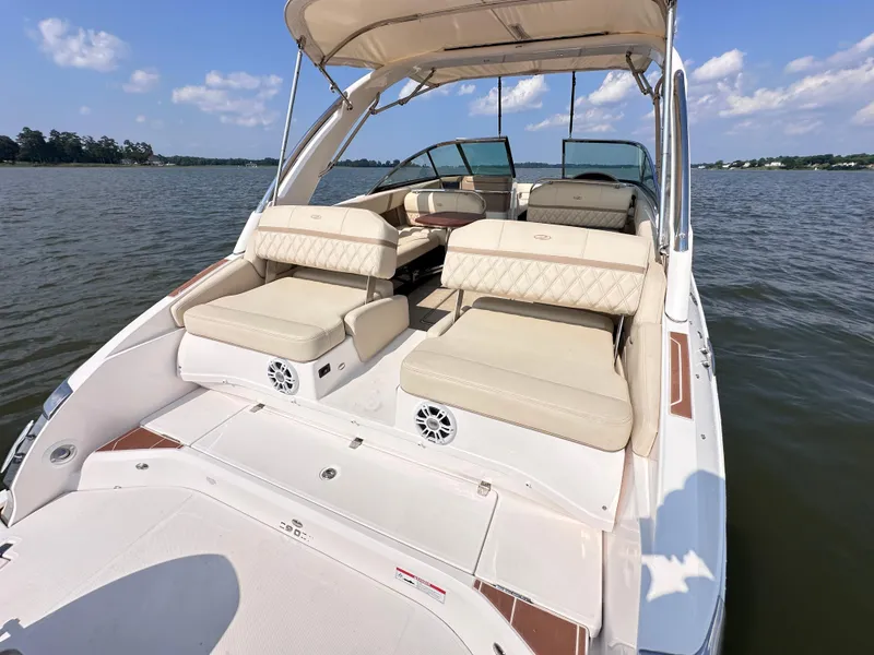 Slide: The Image of 2019 Regal 29 OBX boat with spacious seating on a calm lake. - 19
