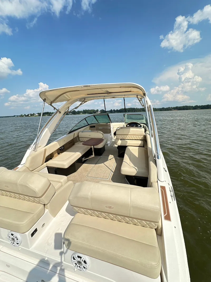 Slide: The Image of 2019 Regal 29 OBX boat with beige seating on a sunny lake. - 21