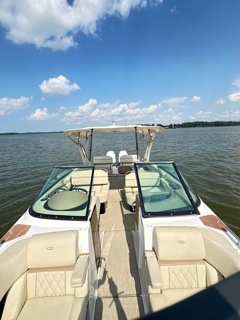 Slide: The Image of 2019 Regal 29 OBX boat on a lake under a clear blue sky. - 22