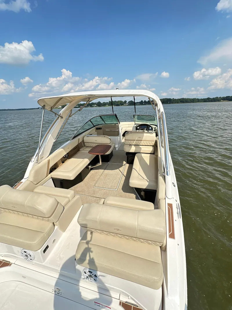 Slide: The Image of 2019 Regal 29 OBX boat with spacious seating on a sunny lake. - 23