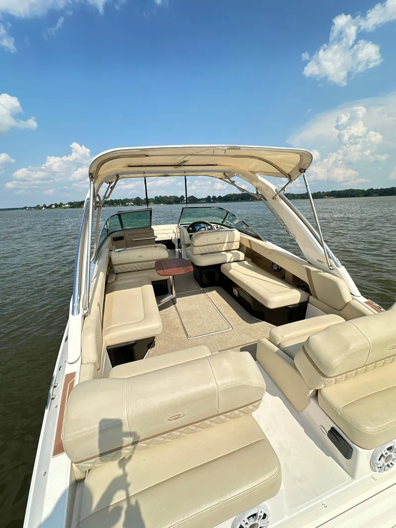 Slide: The Image of 2019 Regal 29 OBX boat with spacious seating on a calm lake. - 24