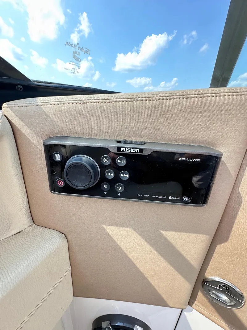 Slide: The Image of Fusion audio system on 2019 Regal 29 OBX boat, under a clear blue sky. - 28