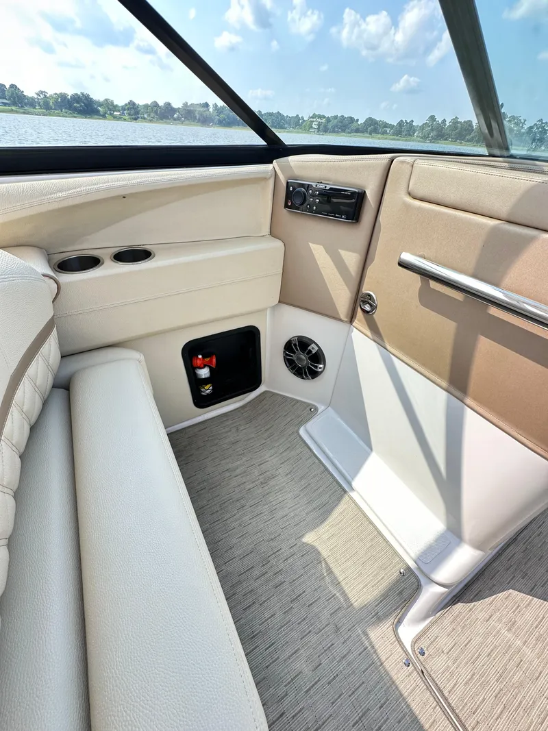 Slide: The Image of Interior view of 2019 Regal 29 OBX boat, featuring beige seating and modern controls. - 29