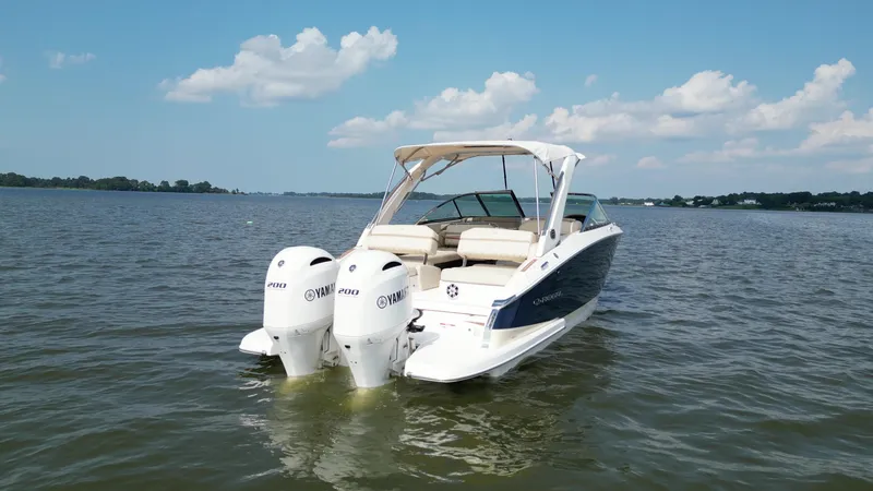 Slide: The Image of 2019 Regal 29 OBX boat with twin Yamaha outboard engines on a calm lake. - 3