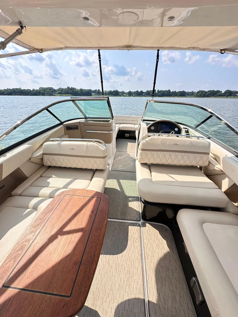 Slide: The Image of 2019 Regal 29 OBX boat interior with luxurious seating and scenic lake view. - 30