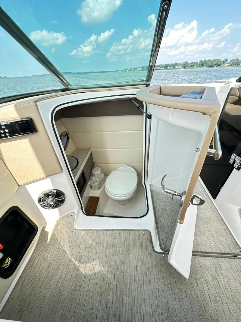 Slide: The Image of 2019 Regal 29 OBX boat interior with compact bathroom, lake view, and modern amenities. - 34
