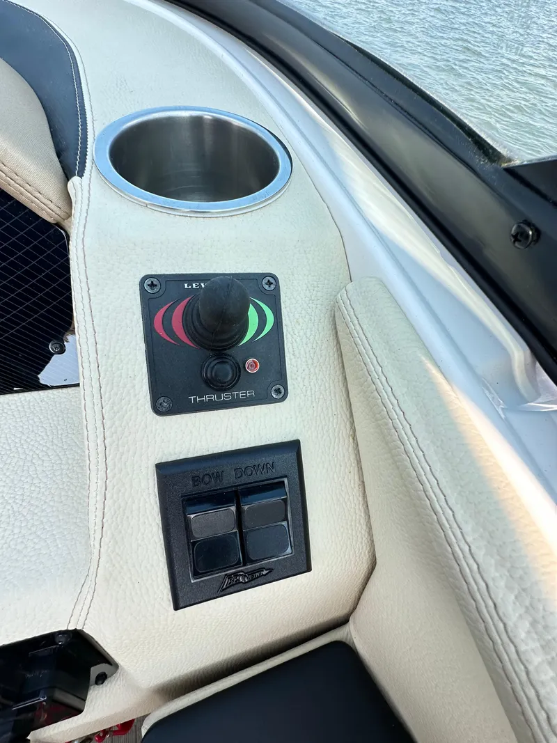 Slide: The Image of 2019 Regal 29 OBX boat control panel with joystick and cup holder. - 36