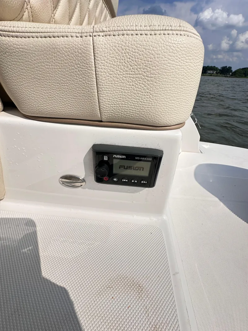 Slide: The Image of 2019 Regal 29 OBX boat interior with Fusion audio system by the water. - 37