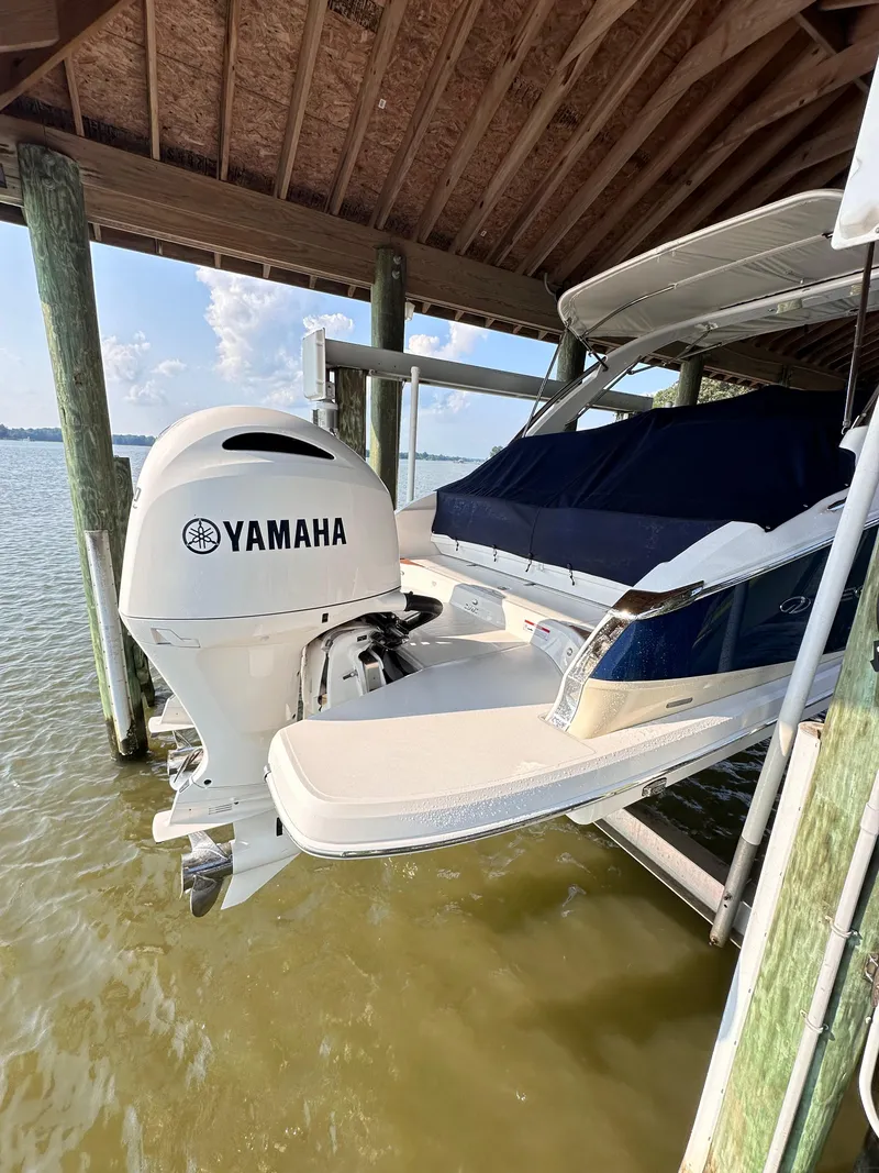 Slide: The Image of 2019 Regal 29 OBX boat with Yamaha outboard motor docked on a lift. - 39