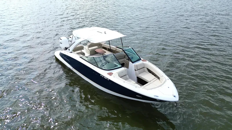 Slide: The Image of 2019 Regal 29 OBX boat on calm water, featuring sleek design and spacious seating. - 4
