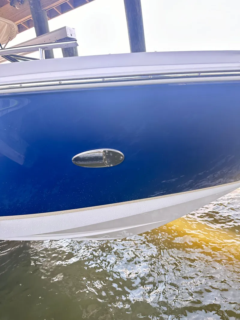 Slide: The Image of 2019 Regal 29 OBX boat with blue hull near water. - 40