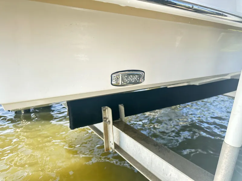 Slide: The Image of 2019 Regal 29 OBX boat hull with underwater light on lift. - 45