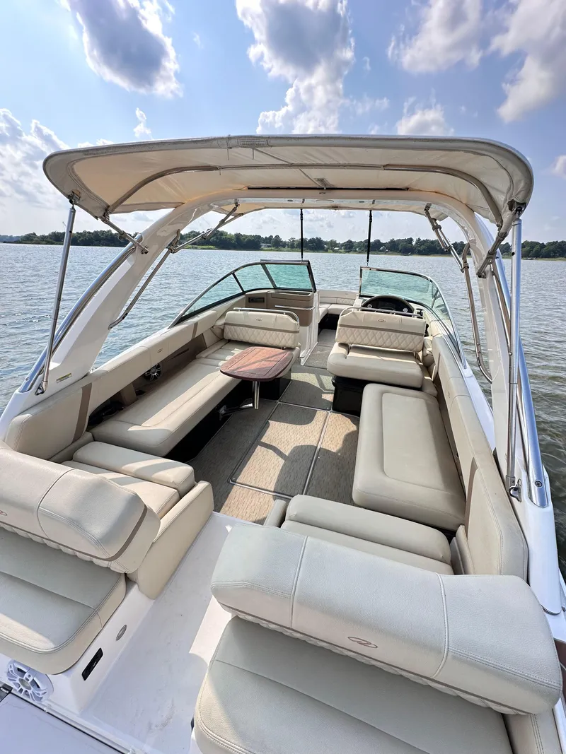 Slide: The Image of 2019 Regal 29 OBX boat with spacious seating and canopy on a sunny day. - 9