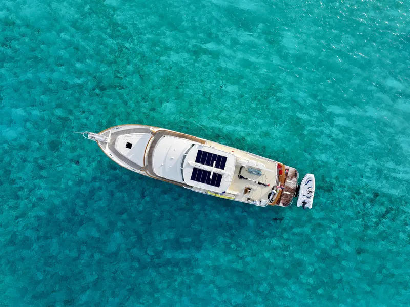 Slide: The Image of Aerial view of Fleming 85 yacht on turquoise water, 2027 model. - 4