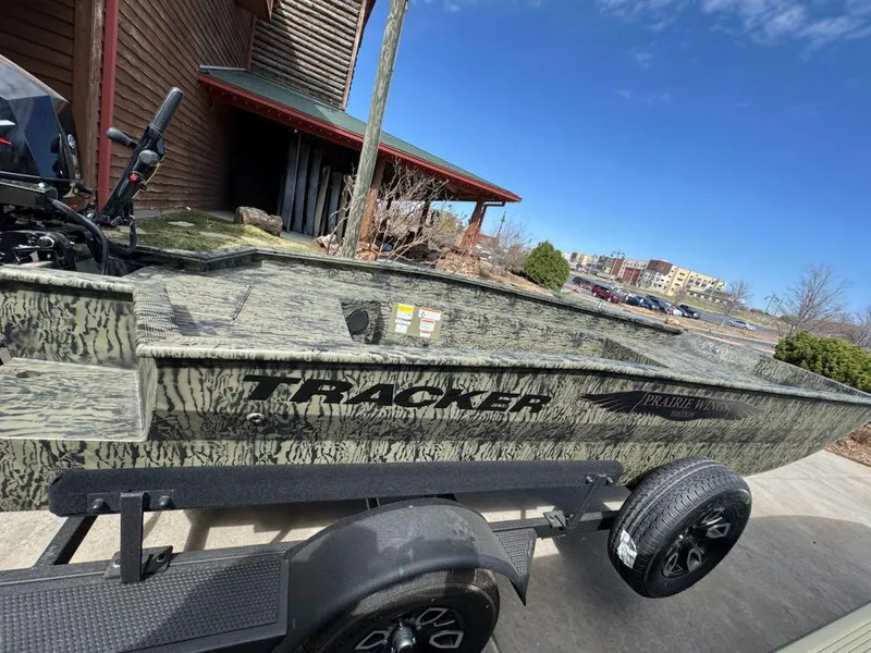 Slide: The Image of 2025 Tracker Grizzly 1650 T Prairie Wings Edition boat on trailer, outdoors. - 5