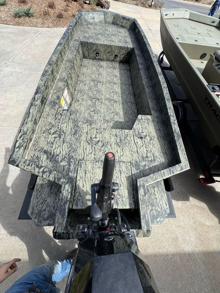 Slide: The Image of 2025 Tracker Grizzly 1650 T Prairie Wings Edition boat with camouflage design on a trailer. - 8
