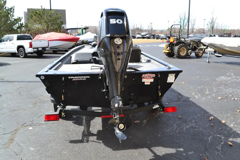 Slide: The Image of 2025 Tracker Pro 170 boat with 50 HP engine, parked outdoors. - 2