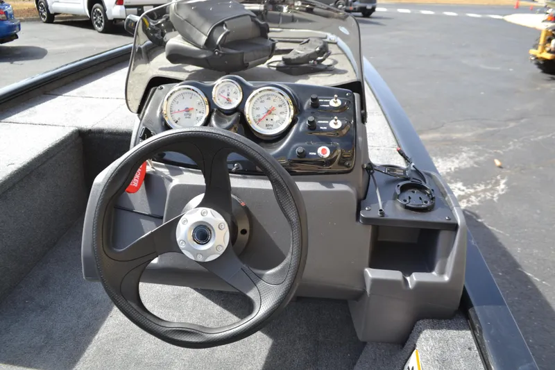 Slide: The Image of 2025 Tracker Pro 170 boat dashboard with steering wheel and gauges. - 3