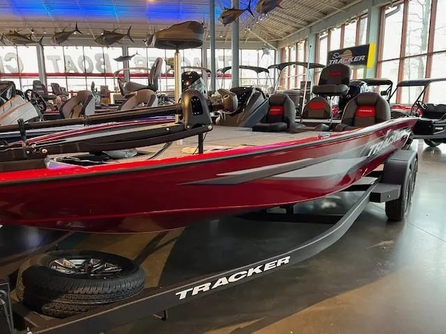 The Image of 2025 Tracker Savage 215 boat in showroom, red exterior, on trailer. - 0