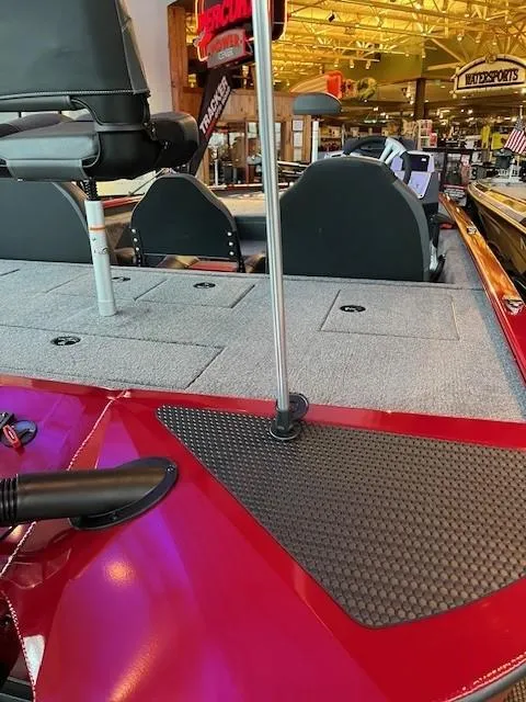 Slide: The Image of 2025 Tracker Savage 215 boat interior with red accents and seating. - 2