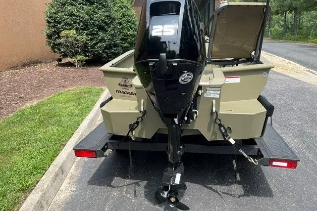Slide: The Image of 2025 Tracker Savage 215 boat with 25 HP outboard motor on trailer. - 99