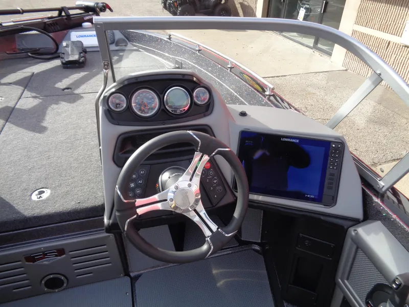 Slide: The Image of 2024 Ranger 620FS Ranger Cup Equipped boat dashboard with steering wheel and navigation display. - 9