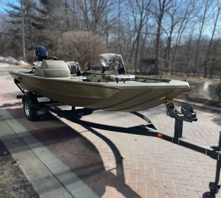 Slide: The Image of 2025 Tracker Grizzly 1754 SC boat on trailer, parked outdoors. - 2