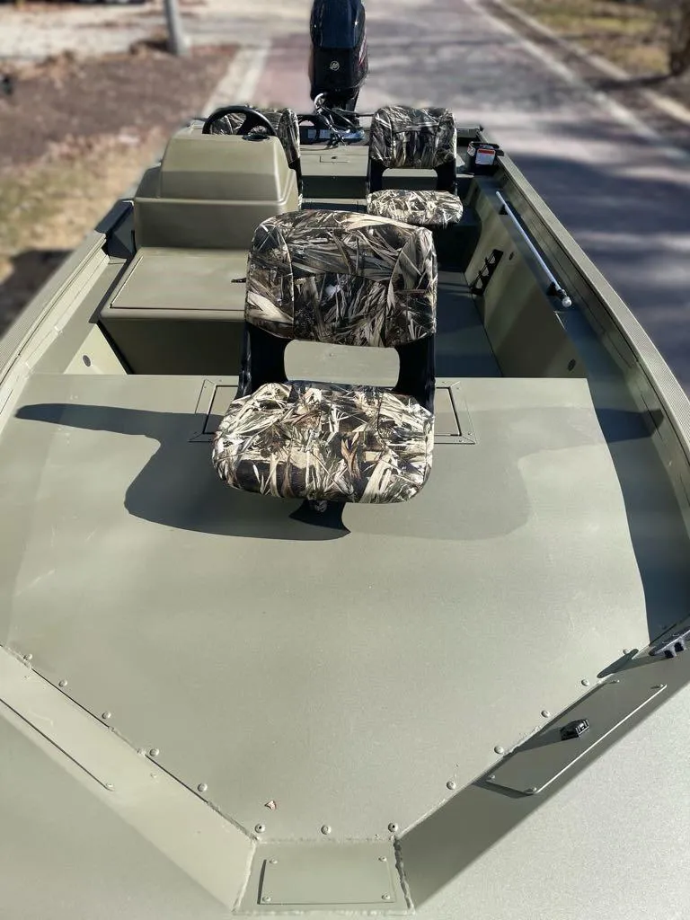 Slide: The Image of 2025 Tracker Grizzly 1754 SC boat with camouflage seats, viewed from the bow. - 4