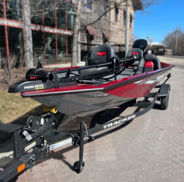 Slide: The Image of 2025 Tracker Pro Team 175 boat with Minn Kota motor, parked on a trailer. - 2