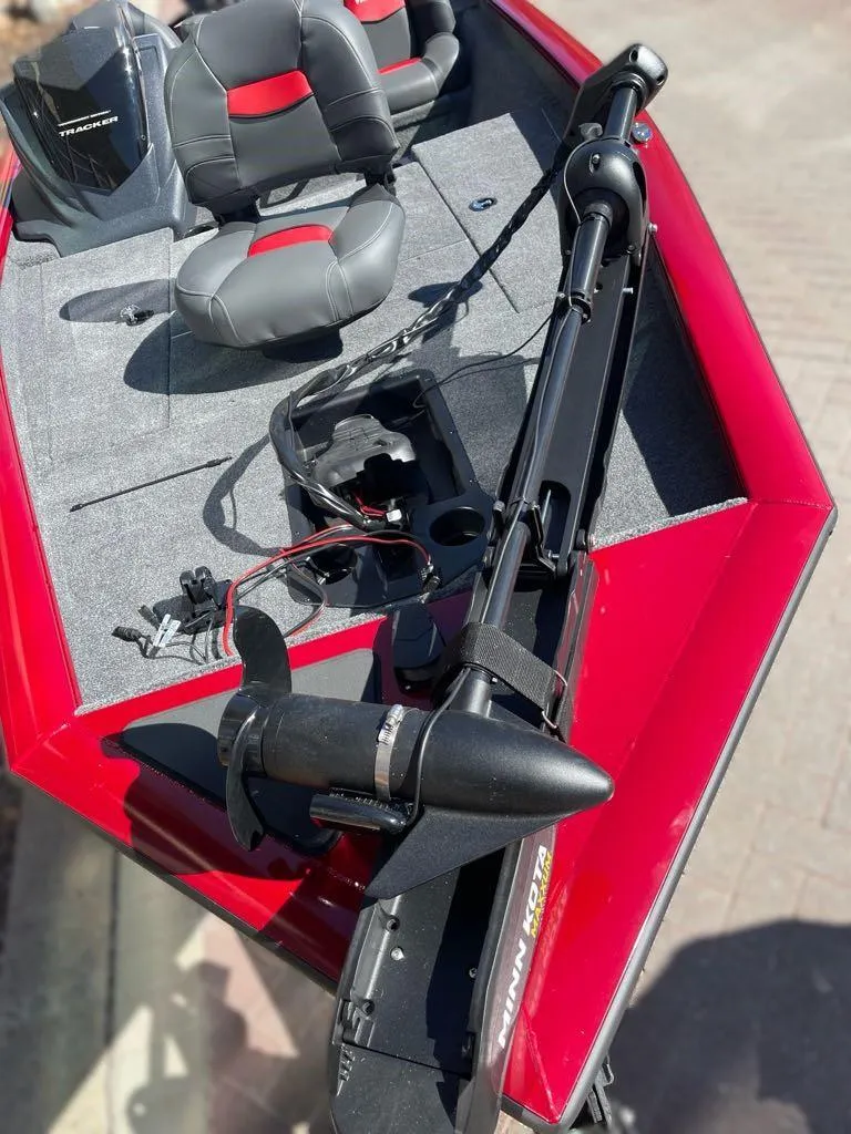 Slide: The Image of 2025 Tracker Pro Team 175 boat with red exterior and dual seats. - 3
