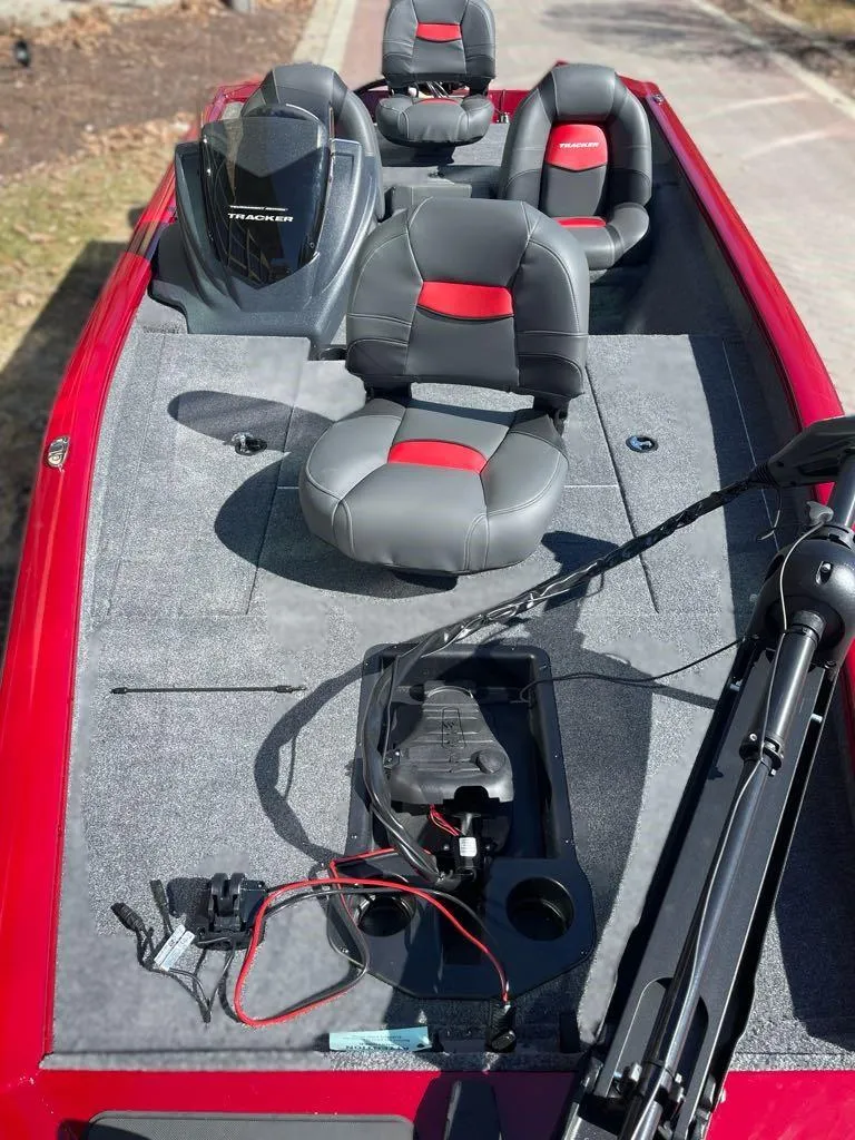 Slide: The Image of 2025 Tracker Pro Team 175 boat with gray and red seating, trolling motor, and spacious deck. - 4