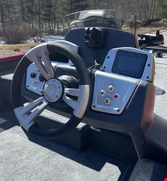 Slide: The Image of 2025 Tracker Pro Team 175 boat dashboard with steering wheel and control panel. - 5
