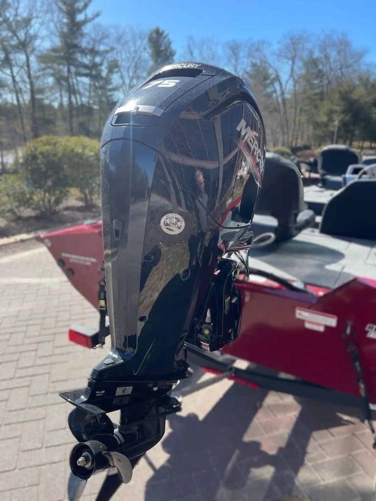 Slide: The Image of 2025 Tracker Pro Team 175 boat with Mercury outboard motor, parked outdoors. - 7