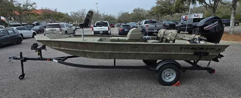 Slide: The Image of 2025 Tracker Grizzly 1754 SC boat on trailer in parking lot. - 2