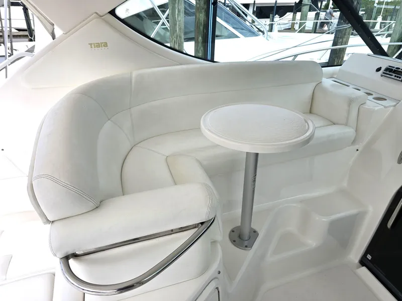 Slide: The Image of 2008 Tiara Yachts 3900 Sovran interior with white seating and small table. - 4