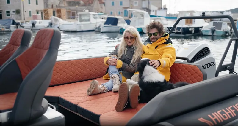 Slide: The Image of Couple and dog relaxing on 2025 Highfield ADV7 boat by the waterfront. - 4