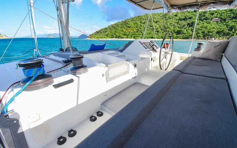 Slide: The Image of 2015 Lagoon 450F yacht cockpit with ocean view and lush island backdrop. - 18