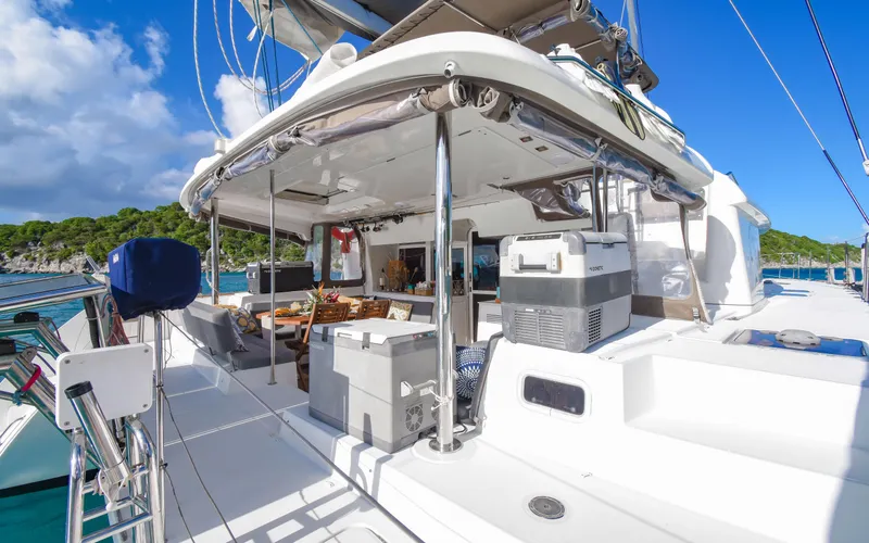 Slide: The Image of 2015 Lagoon 450F catamaran with spacious deck and modern amenities, docked in a scenic marina. - 20
