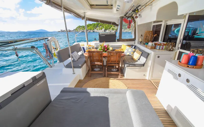 Slide: The Image of Luxurious Lagoon 450F 2015 yacht interior with dining area, ocean view, and comfortable seating. - 21