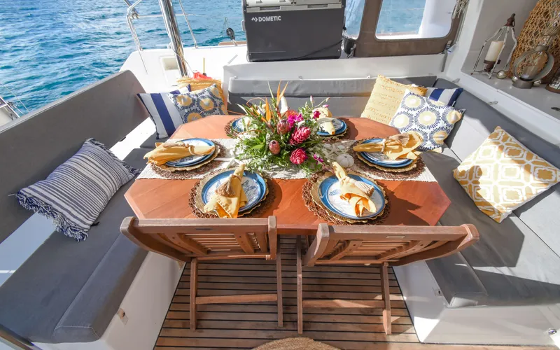 Slide: The Image of Luxurious dining setup on 2015 Lagoon 450F yacht with elegant tableware and floral centerpiece. - 23